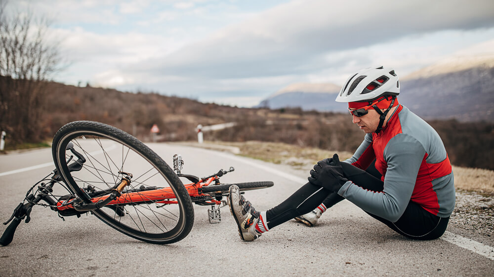 Man who has fallen off his bike