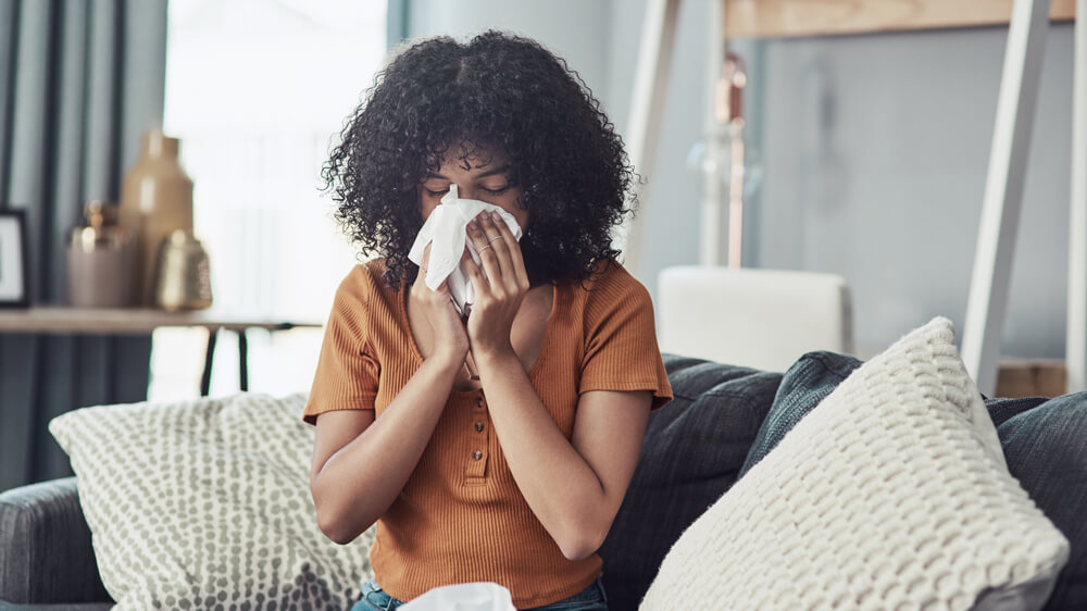 Woman blowing her nose