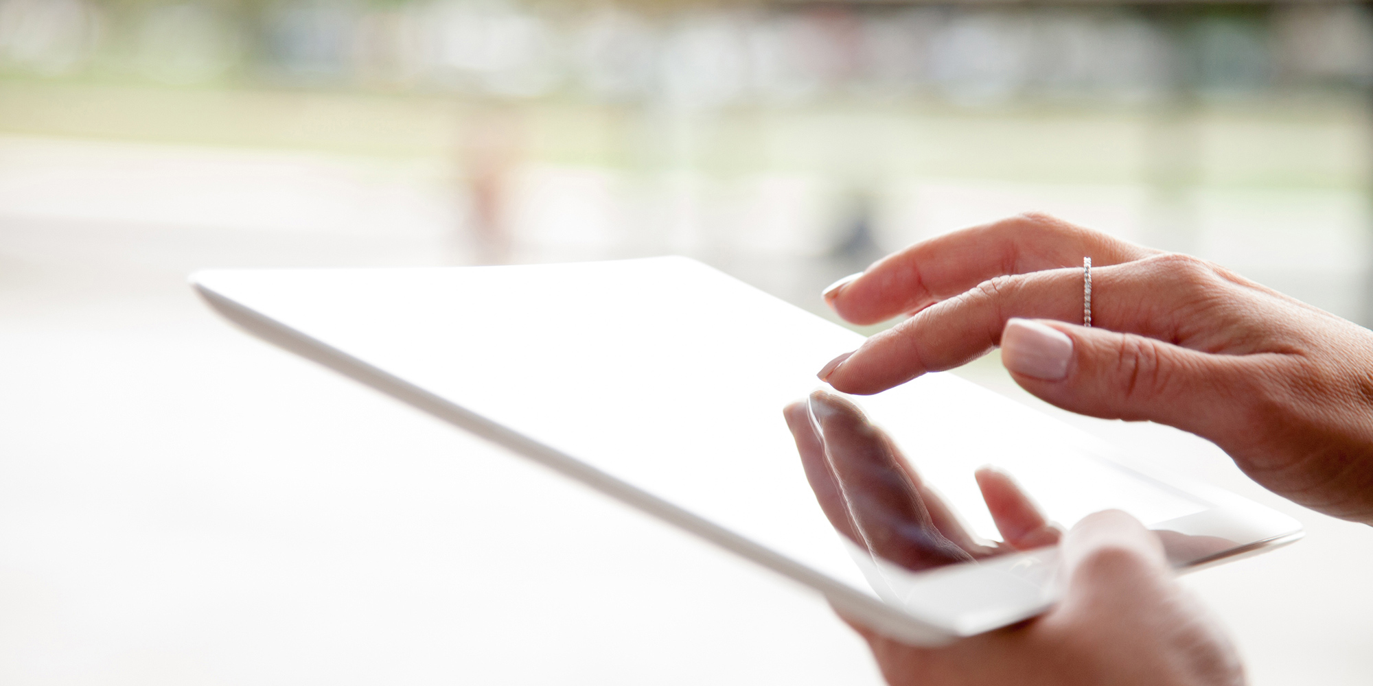 Woman's hands using tablet