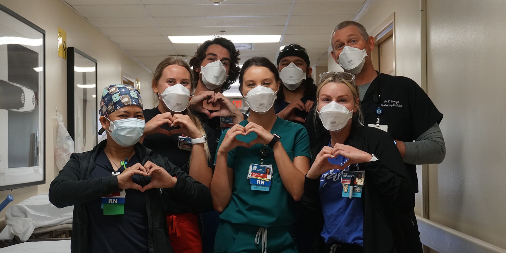 Group of medical professionals making the heart shape with their hands