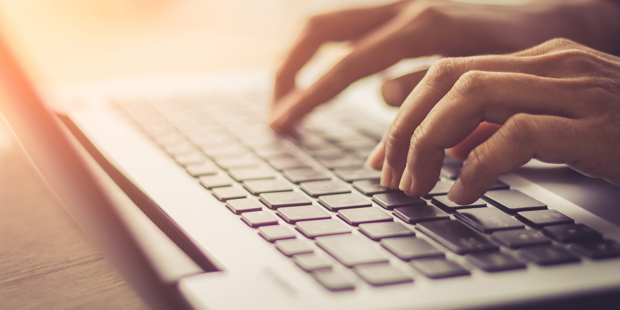Hands typing on a keyboard