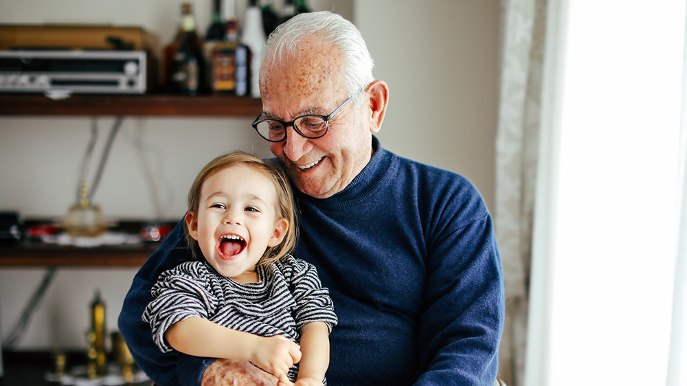 Older male holding child