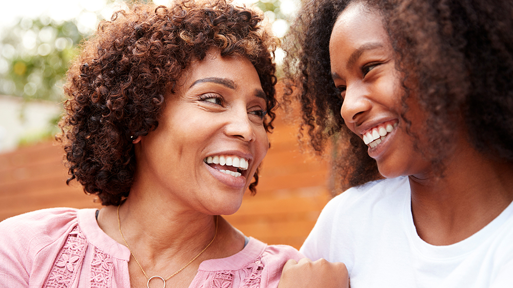 Mother and daughter laughing together