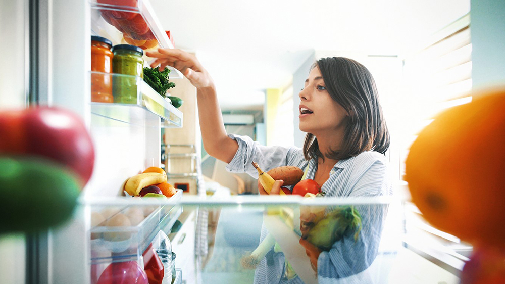 Woman looking in fridge