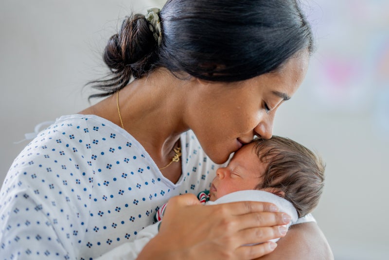 mother kissing baby