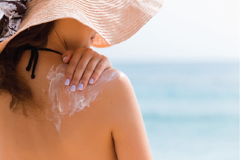 woman applying sunscreen