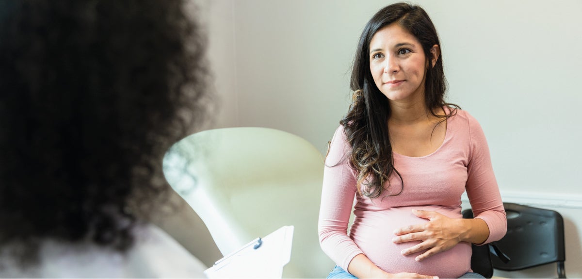 Pregnant person talking to doctor