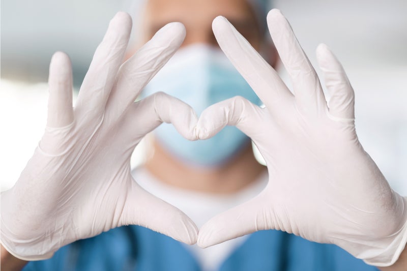 Surgeon with hands in a heart shape