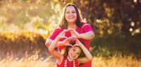 Mom and daughter with heart hands